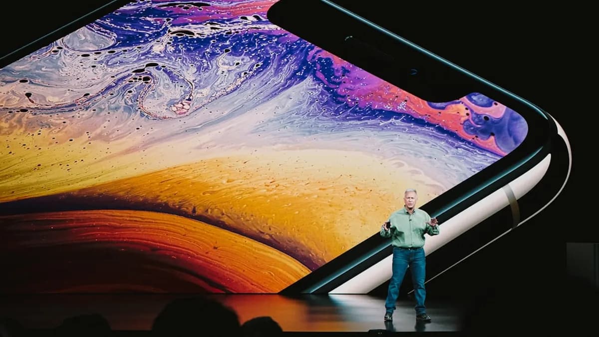 man in white shirt and blue denim jeans standing on blue and yellow water