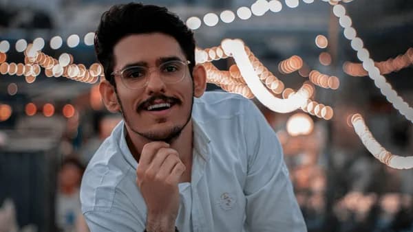 a man with glasses is posing for a picture