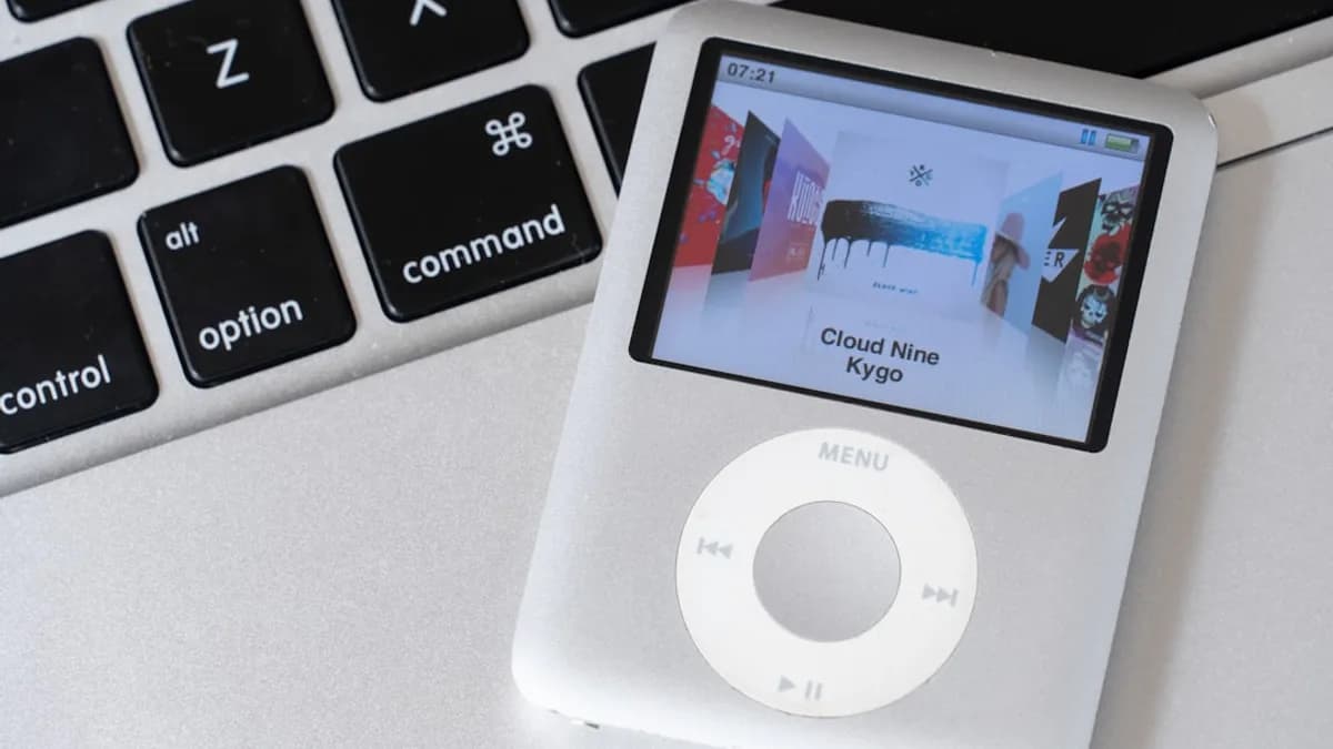 an ipod sitting on top of a laptop keyboard