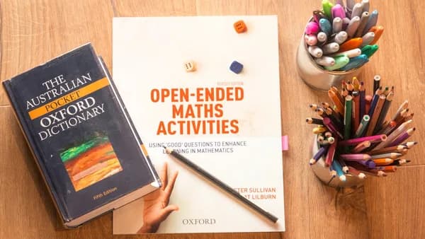 person holding a book and pen