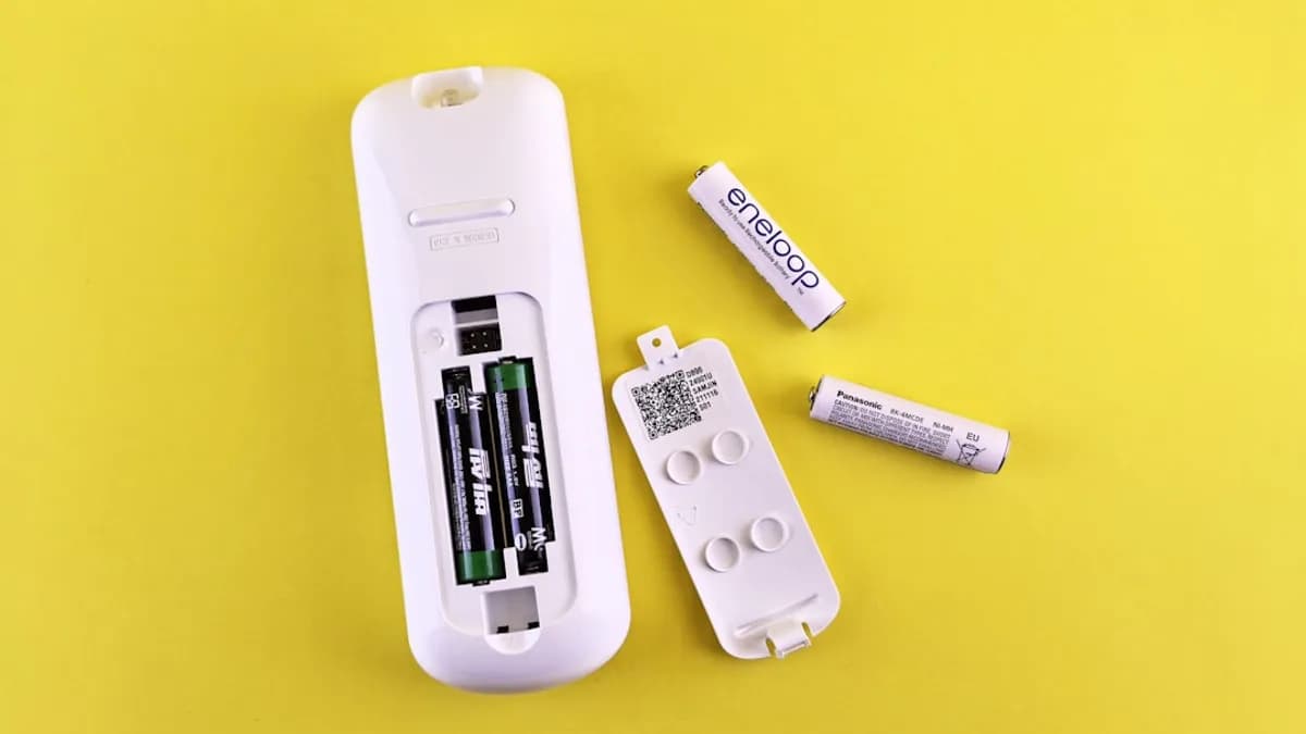 A couple of remote controls sitting on top of a table