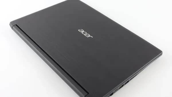 a laptop computer sitting on top of a white table