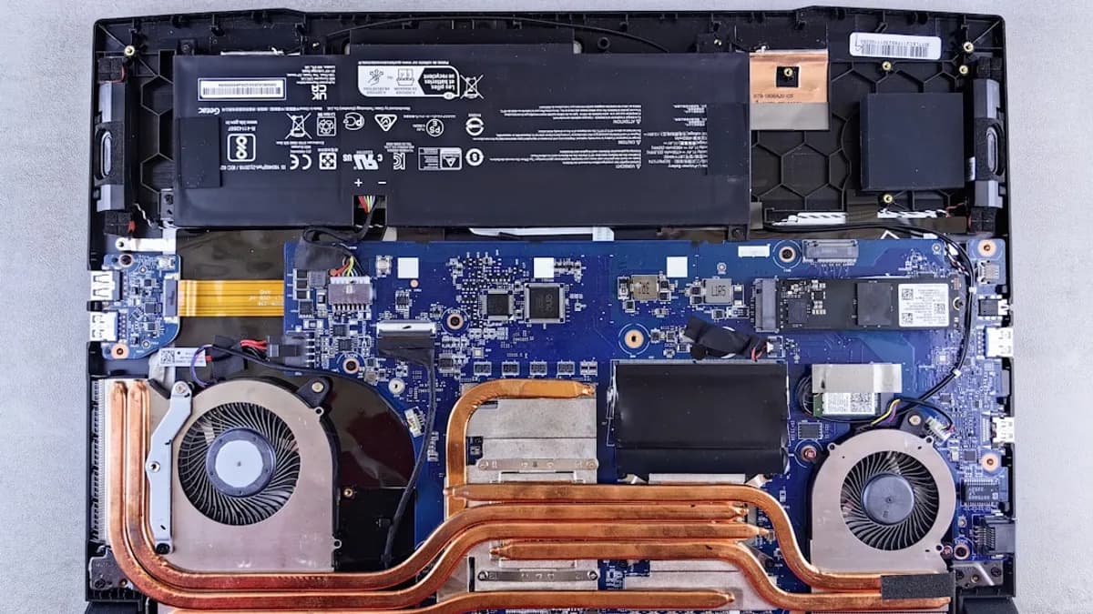 the motherboard of a laptop is being dismantled