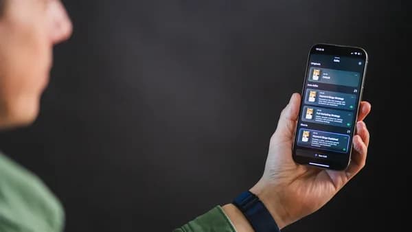Man holding smartphone with app interface
