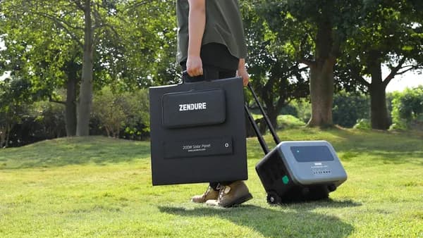a man with a suitcase and a radio in the grass