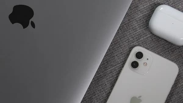 white apple remote beside white remote control
