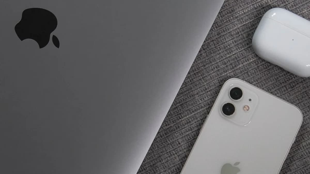 white apple remote beside white remote control
