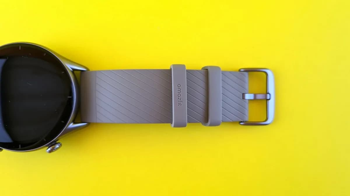 a smart watch sitting on a yellow surface