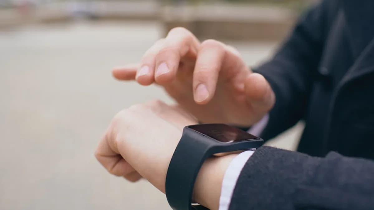 Person using a smartwatch on their wrist.