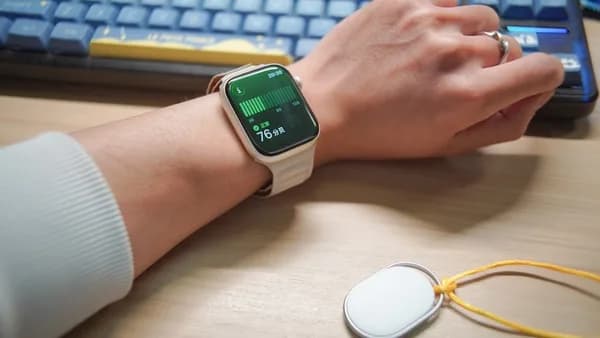 Person wearing a smartwatch with a keyboard in-ear monitor.