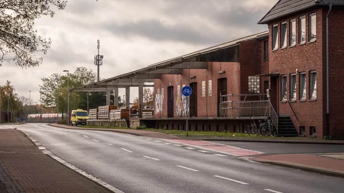 Brick building with covered loading dock and road.