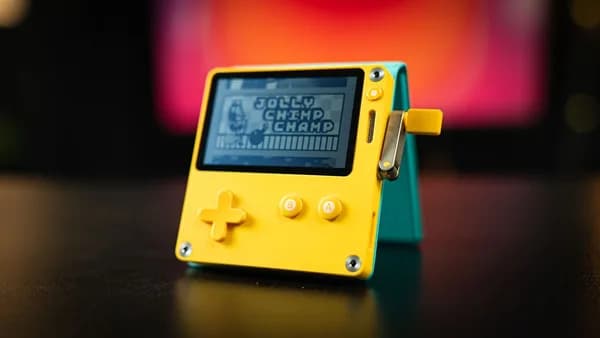 a yellow gameboy sitting on top of a table