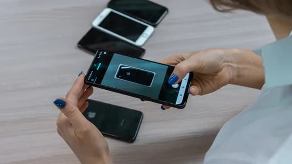 a woman holding a smart phone in her hands