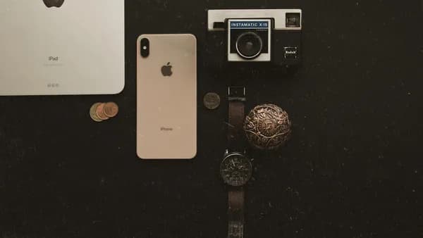an iphone, watch, and other items on a table