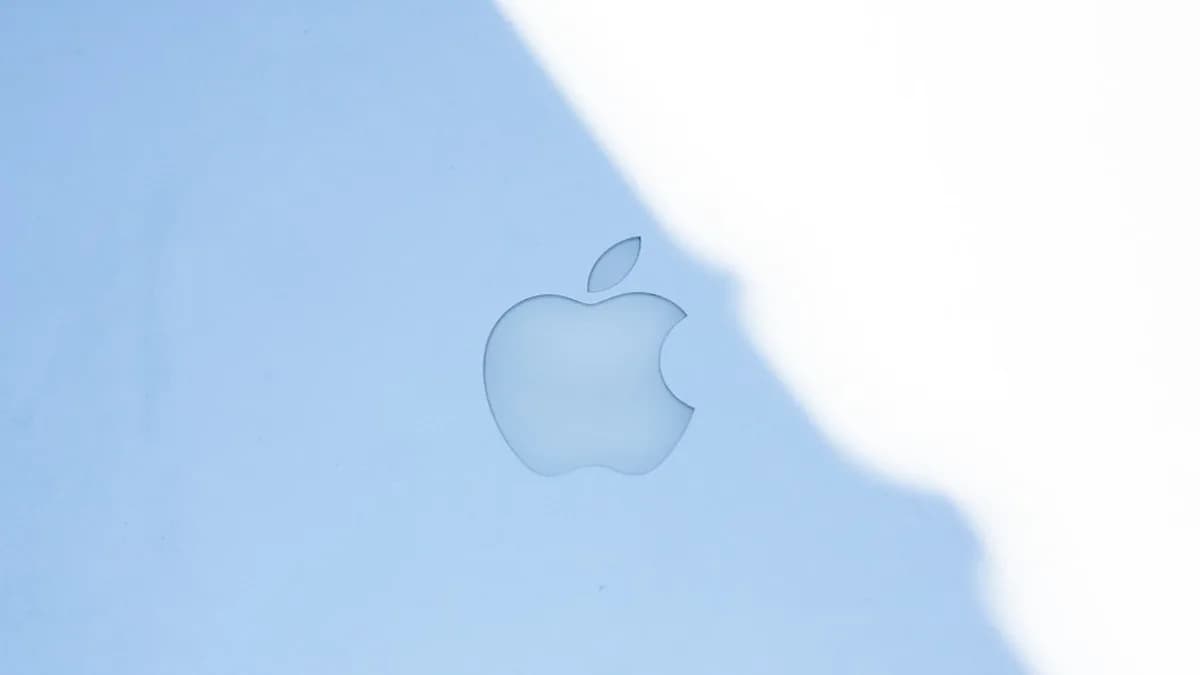 The apple logo on a blue surface.