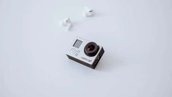 white and black camera on white surface