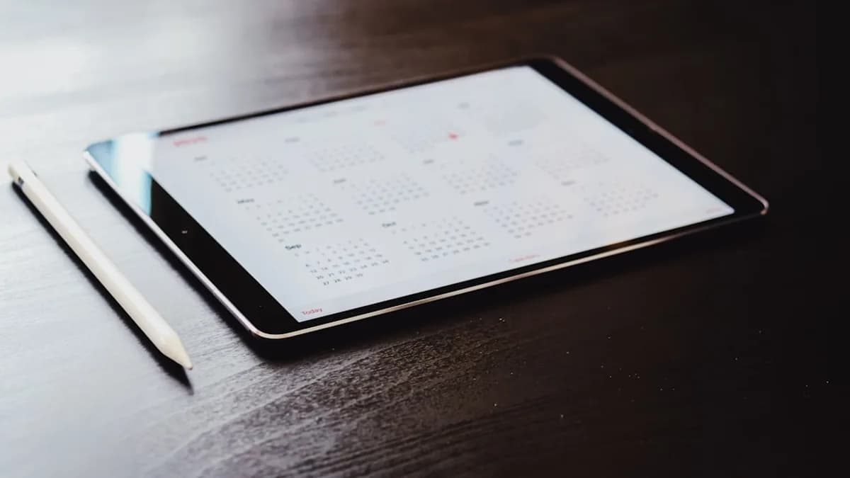 white ipad on brown wooden table