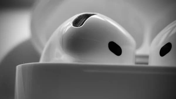 Close-up of white wireless earbuds in charging case