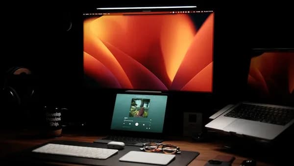 a laptop computer sitting on top of a wooden desk