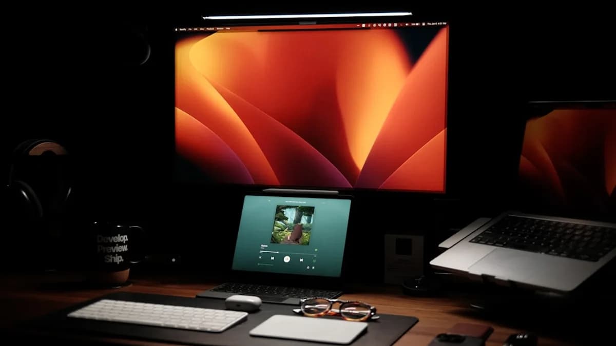 a laptop computer sitting on top of a wooden desk