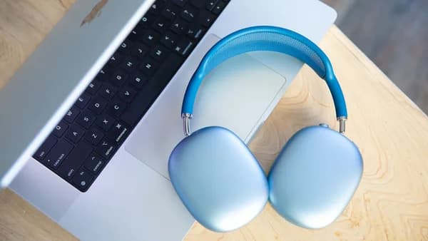 a pair of headphones sitting next to a laptop