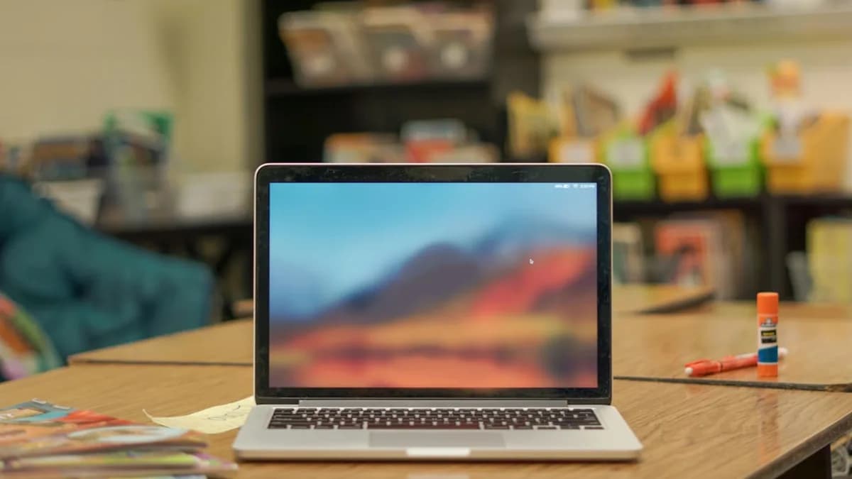 macbook pro on brown wooden table