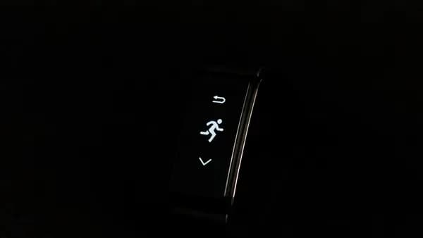 a close up of a watch on a black surface