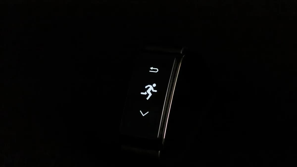 a close up of a watch on a black surface