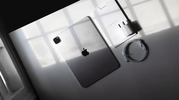 an apple product is displayed on a white surface
