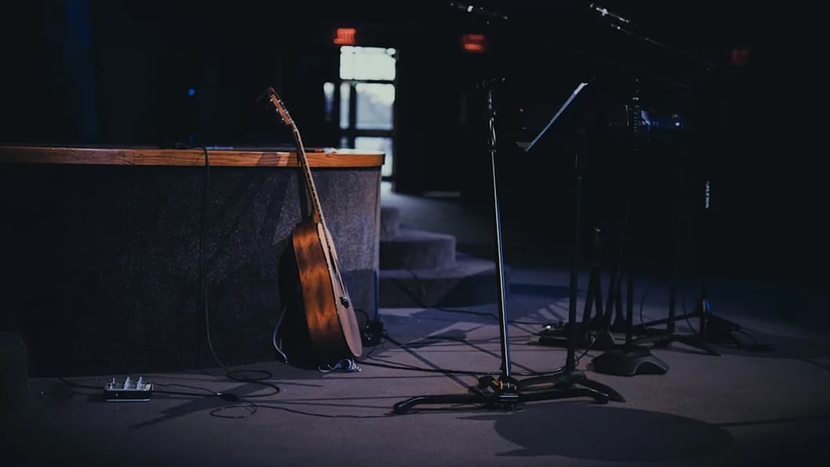 a guitar and a microphone in a dark room
