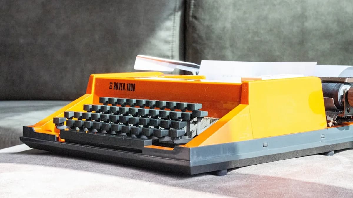 a toy typewriter sitting on a table next to a couch