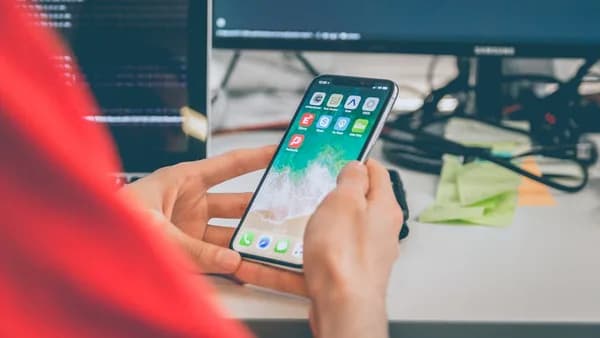 person using silver iPhone X