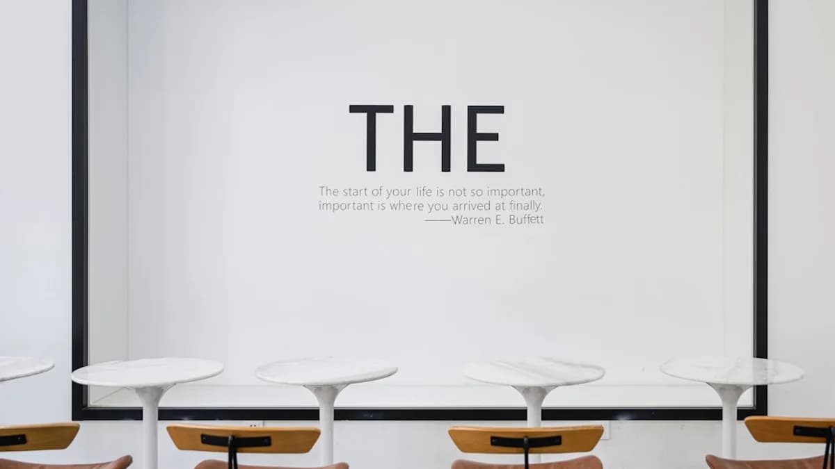 a group of chairs sitting in front of a white wall