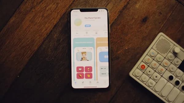 a cell phone sitting next to a remote control