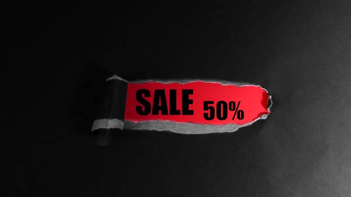 Red tag with "sale 50%" text on black background