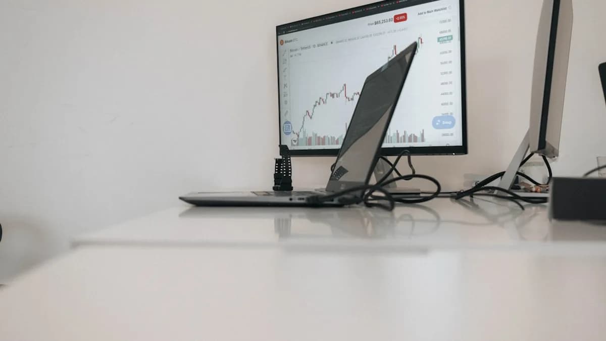 a desk with a laptop and a monitor on it