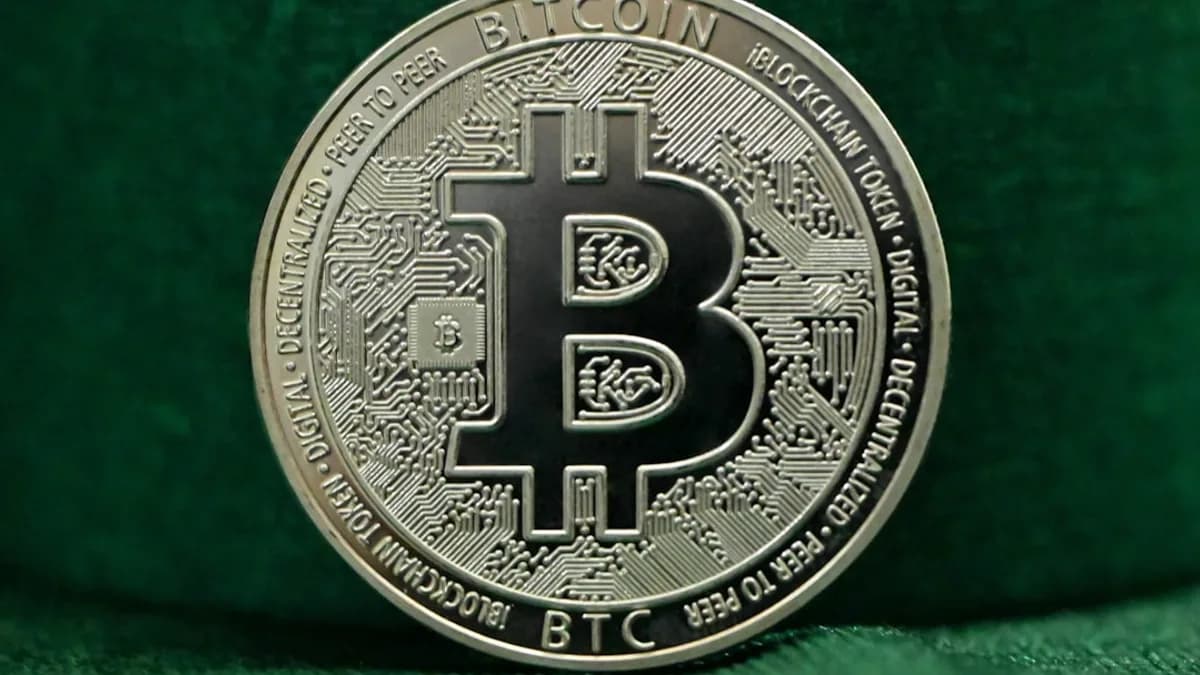 a bit coin sitting on top of a green cloth