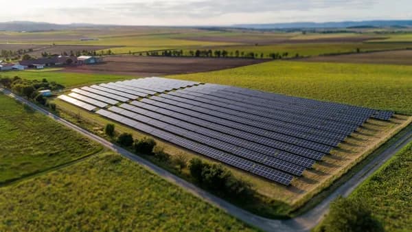 black solar panels on green grass field during daytime