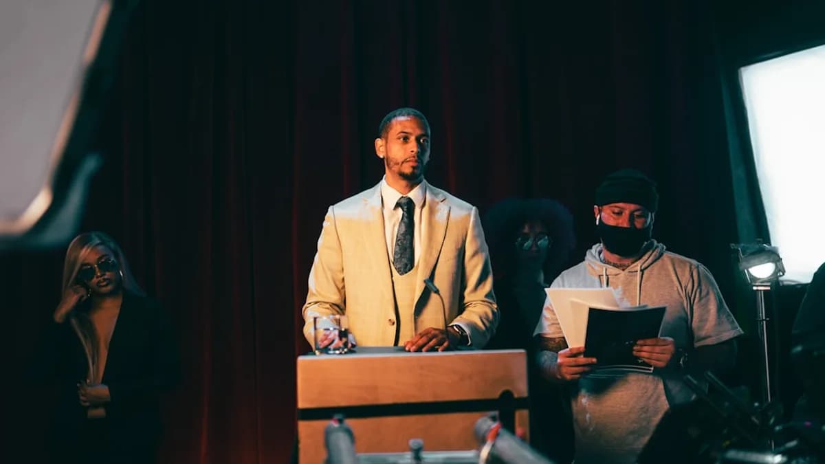 man in white suit standing beside man in black suit