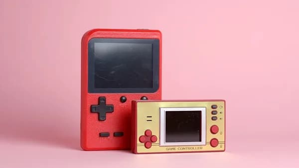 a red nintendo game boy next to a red box