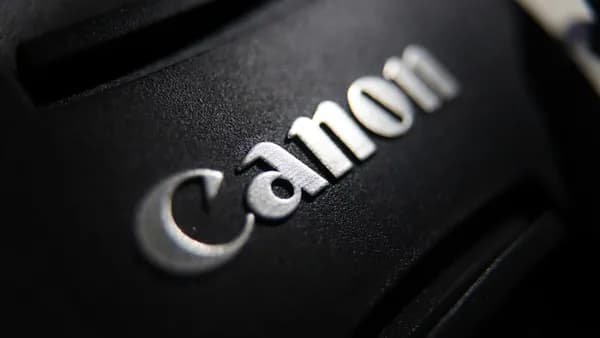 Close-up of the canon logo on a black surface.