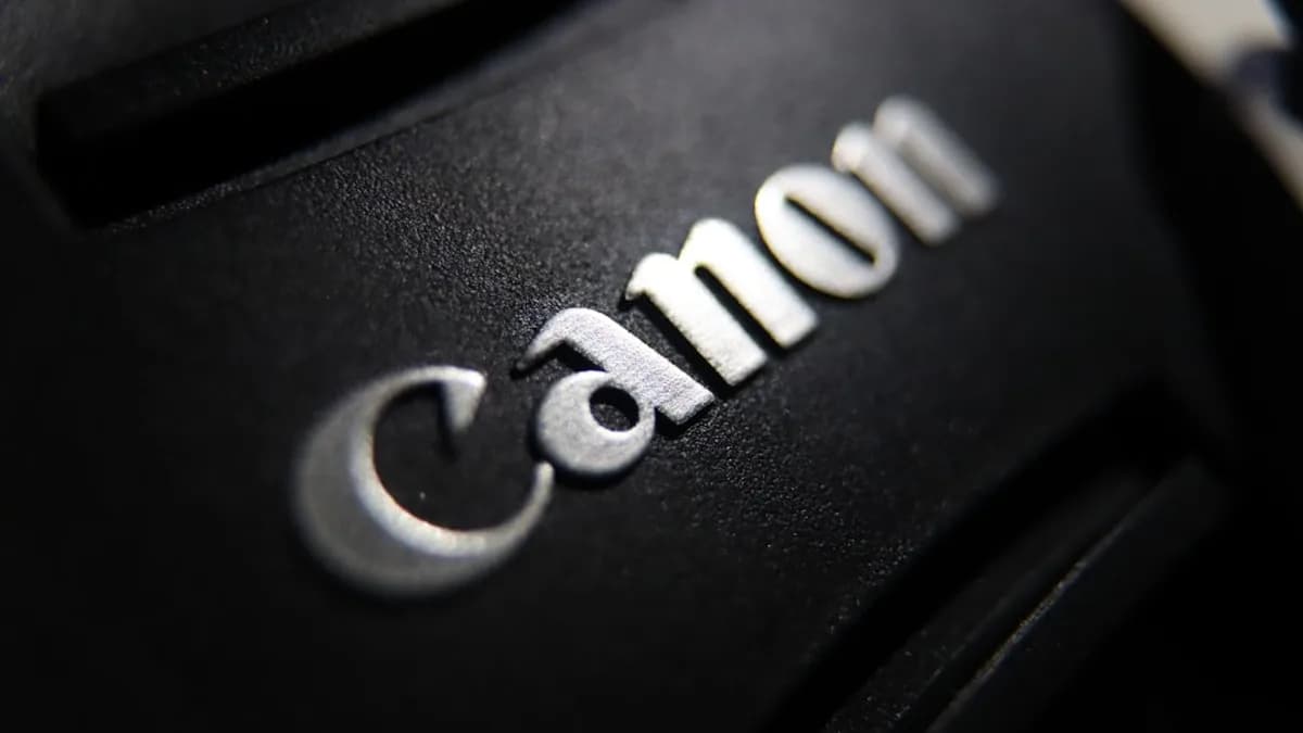 Close-up of the canon logo on a black surface.