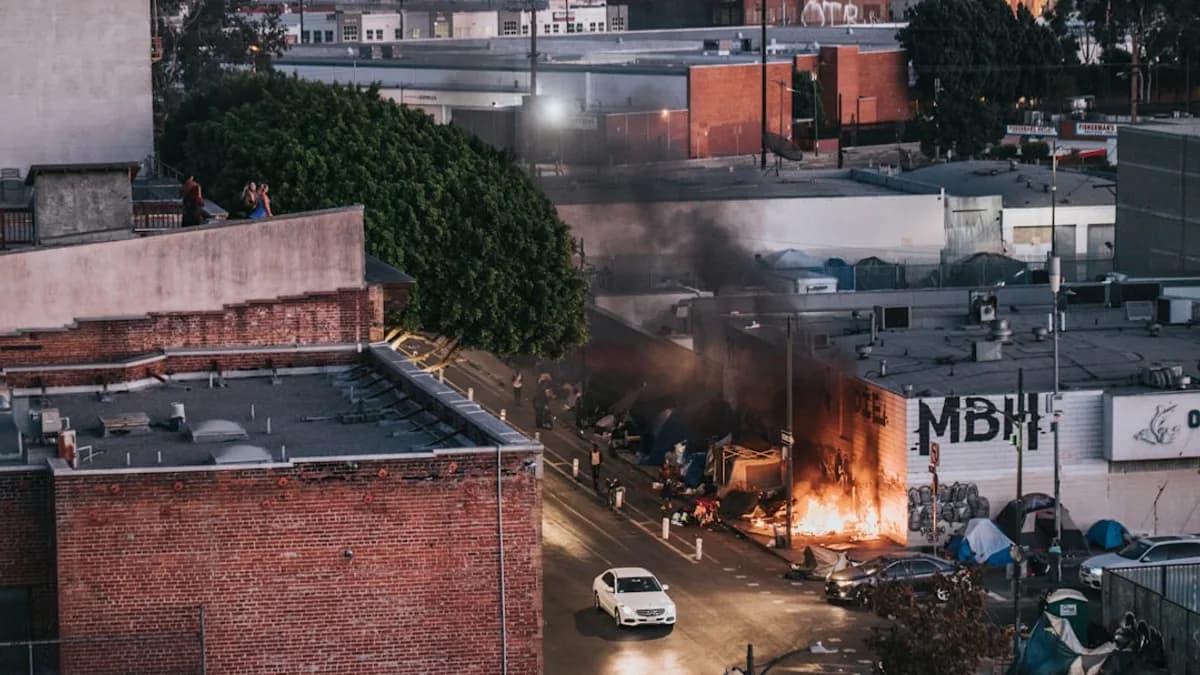 cars parked beside brown brick building during daytime