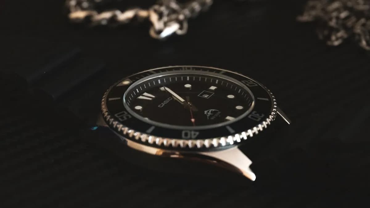 a watch sitting on top of a black table