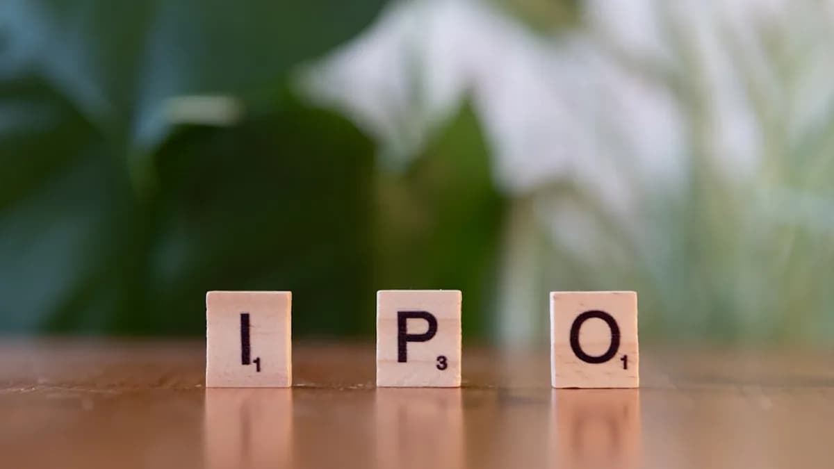 A wooden block spelling the word ipo on a table