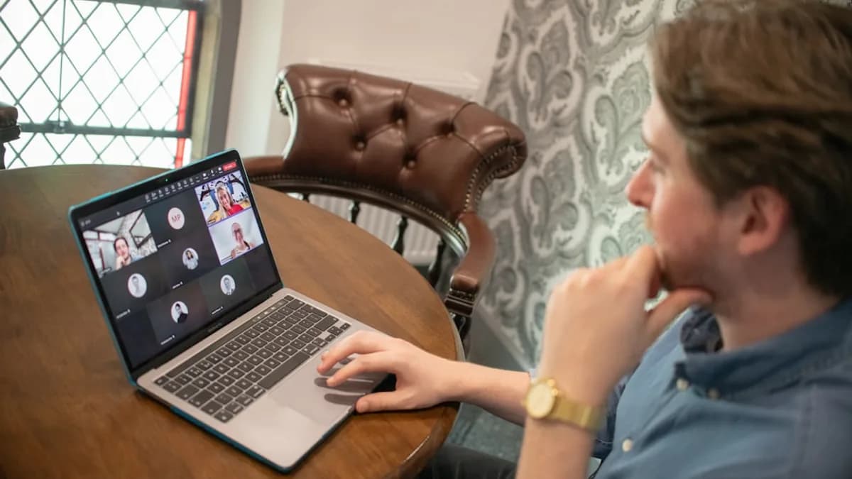 Man on laptop participating in a video conference call.
