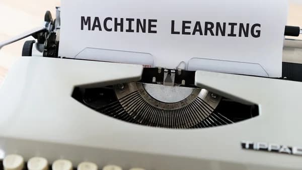 a close up of a typewriter with a paper reading machine learning
