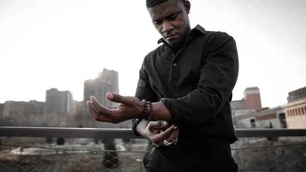 man in black zip up jacket holding smartphone