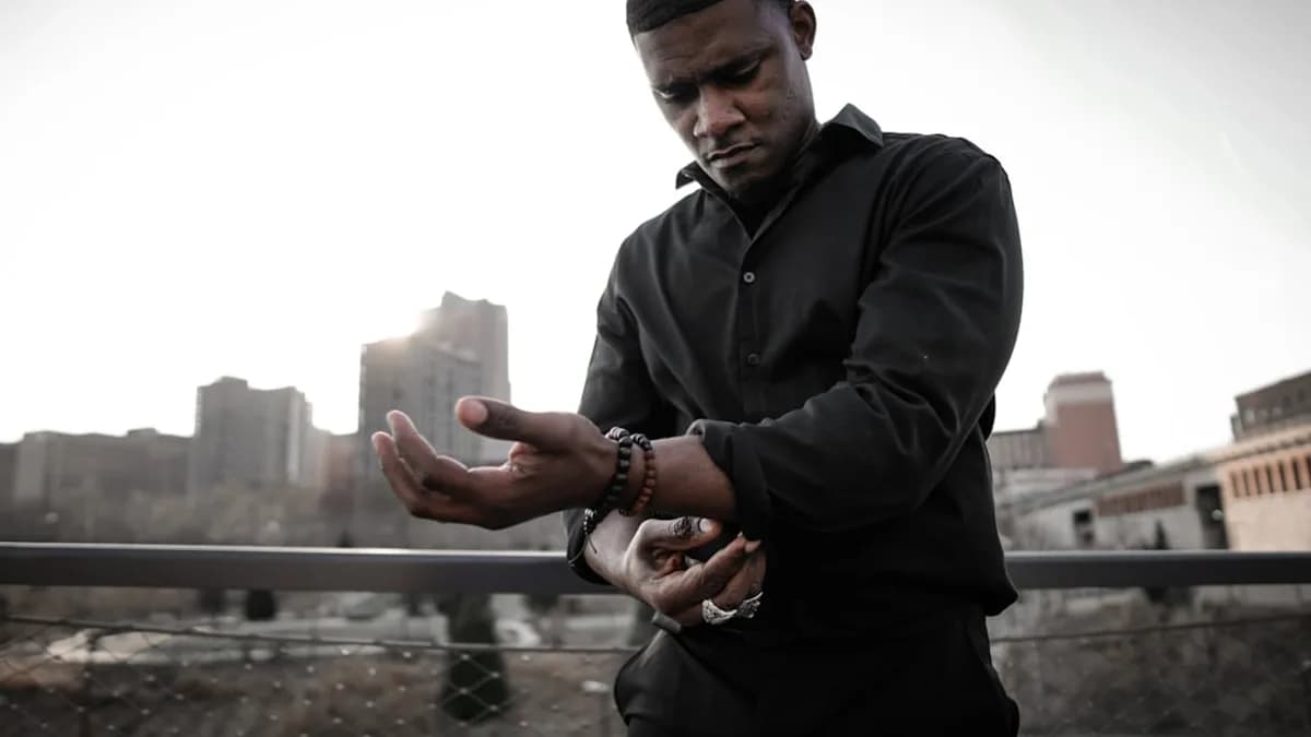 man in black zip up jacket holding smartphone