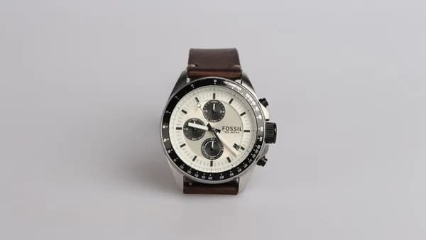 round silver-colored Fossil chronograph watch at 9:22 with brown leather band